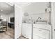 Convenient laundry room featuring a washer, dryer, and storage space at 2101 Cordova Grn, Seminole, FL 33777