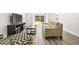 Inviting living room area with a comfortable couch, media center, and access to outdoor space at 2101 Cordova Grn, Seminole, FL 33777