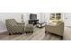 Comfortable living room with access to outdoors, featuring a stylish chair and entertainment center at 2101 Cordova Grn, Seminole, FL 33777