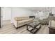 Comfortable living room with neutral-toned sofa and stylish coffee table and view to kitchen at 2101 Cordova Grn, Seminole, FL 33777