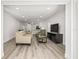 Bright living room with a sofa, a unique armchair, and an open layout to the kitchen at 2101 Cordova Grn, Seminole, FL 33777
