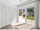 Bright room with light wood floors, full-wall closet, and sliding glass doors to the patio at 2101 Cordova Grn, Seminole, FL 33777