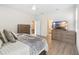 Cozy bedroom shows furnishings, including a dresser and mounted television at 219 Villa Luna Ln, Lutz, FL 33549