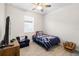 Bedroom featuring a ceiling fan and a window at 219 Villa Luna Ln, Lutz, FL 33549