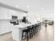 Bright, open kitchen with an island, modern appliances, and seamless flow to dining area at 219 Villa Luna Ln, Lutz, FL 33549