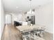 Bright, open kitchen and dining area features stainless steel appliances and a large island with breakfast bar seating at 219 Villa Luna Ln, Lutz, FL 33549