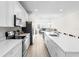 Bright, open kitchen with an island, modern appliances, and seamless flow to living area at 219 Villa Luna Ln, Lutz, FL 33549