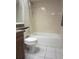 The bathroom has tiled floors and walls, a bathtub with a shower curtain, and a vanity at 233 Woodlake Wynde, Oldsmar, FL 34677