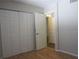 Cozy bedroom features hardwood floors, a closet, and natural light at 233 Woodlake Wynde, Oldsmar, FL 34677