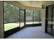 Screened lanai with tile floors, offering views of the landscaped backyard and private outdoor space at 233 Woodlake Wynde, Oldsmar, FL 34677