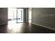 Neutral living room with hardwood floors and natural light with access to the screened in lanai at 233 Woodlake Wynde, Oldsmar, FL 34677