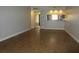 Spacious living room with wood-look flooring, neutral walls, and access to other rooms at 233 Woodlake Wynde, Oldsmar, FL 34677
