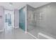Modern bathroom with a glass-enclosed shower, and entry to main bedroom with ocean views at 301 1St S St # 3103, St Petersburg, FL 33701