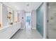 Bright bathroom featuring a double vanity, glass shower, and entry to main bedroom with ocean views at 301 1St S St # 3103, St Petersburg, FL 33701