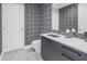 Stylish powder room with geometric wallpaper and a floating vanity at 301 1St S St # 3103, St Petersburg, FL 33701