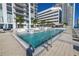 Inviting rooftop pool area surrounded by palm trees and comfortable lounge seating at 301 1St S St # 3103, St Petersburg, FL 33701