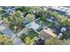 An aerial view of a home with a fenced yard, mature trees, and a detached garage at 304 David Ave, Clearwater, FL 33759