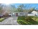 Charming home with a well-manicured lawn and a concrete driveway at 304 David Ave, Clearwater, FL 33759
