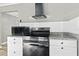 Bright kitchen showcasing stainless steel oven and microwave appliances, complemented by granite countertops at 304 David Ave, Clearwater, FL 33759