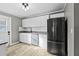 Bright kitchen with white cabinets and stainless steel appliances at 304 David Ave, Clearwater, FL 33759