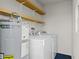 Laundry room with shelves, washer and dryer at 304 David Ave, Clearwater, FL 33759