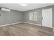 A cozy living room with modern floors and a window at 304 David Ave, Clearwater, FL 33759