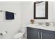 Modern half bath featuring a dark vanity, marble countertop, and stylish fixtures at 3280 Juniper Springs St, Wesley Chapel, FL 33543