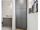 Bathroom with gray vanity, gray cabinets, a sink, and a shelf filled with books at 3280 Juniper Springs St, Wesley Chapel, FL 33543