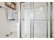 Bright bathroom with a white tiled shower, glass door and brushed nickel fixtures at 3280 Juniper Springs St, Wesley Chapel, FL 33543