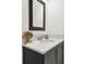 Close-up of stylish half bath featuring vanity with marble top, and decorative elements at 3280 Juniper Springs St, Wesley Chapel, FL 33543