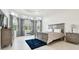 Bright, spacious bedroom with tray ceilings, large windows, and elegant furnishings at 3280 Juniper Springs St, Wesley Chapel, FL 33543