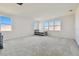 Spacious bonus room with plush carpeting, bright windows, and a small bed at 3280 Juniper Springs St, Wesley Chapel, FL 33543