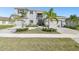 Elegant two-story home boasts a three-car garage and meticulous landscaping with lush palm trees at 3280 Juniper Springs St, Wesley Chapel, FL 33543