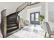 Grand foyer with curved staircase, white tile floors, and modern decor at 3280 Juniper Springs St, Wesley Chapel, FL 33543