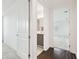 Hallway with a bathroom view and bedroom view, showcasing hardwood and carpet floors at 3280 Juniper Springs St, Wesley Chapel, FL 33543