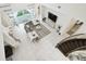 Bright living room with white tile floors, modern gray sofa, and staircase at 3280 Juniper Springs St, Wesley Chapel, FL 33543
