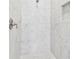 Walk-in shower featuring white marble tile and built-in niche for toiletries at 3280 Juniper Springs St, Wesley Chapel, FL 33543