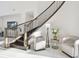Modern staircase with wooden rails, white walls, marble floors and decor seating area at 3280 Juniper Springs St, Wesley Chapel, FL 33543