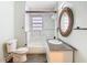 Bright bathroom featuring marble tile surround, modern fixtures, and a vanity with granite countertop at 3406 E 29Th Ave, Tampa, FL 33605