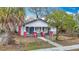 Inviting home featuring a charming facade with classic architectural details, a well-kept yard, and a secure fence at 3406 E 29Th Ave, Tampa, FL 33605