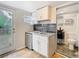 Efficient kitchen featuring stainless appliances and adjoining bath at 3406 E 29Th Ave, Tampa, FL 33605