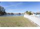 Lawn with view of the lake and community with a white fence at 3857 Sailmaker Ln, Holiday, FL 34691