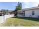 Fully fenced private backyard with enclosed patio space and partial view of neighboring units at 3857 Sailmaker Ln, Holiday, FL 34691