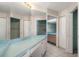 Bathroom vanity with large mirrors, dual closets, and walk-in shower at 3857 Sailmaker Ln, Holiday, FL 34691