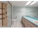 Bathroom featuring walk-in shower, accessible features and double vanity at 3857 Sailmaker Ln, Holiday, FL 34691