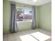 Bedroom with tile floor and large window at 3857 Sailmaker Ln, Holiday, FL 34691