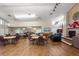 A bright and airy common room with wood floors offers a relaxing space with a fireplace and comfortable seating options at 3857 Sailmaker Ln, Holiday, FL 34691