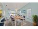 Bright dining room with a butcher block dining table, pendant lighting, and sliding glass doors at 3857 Sailmaker Ln, Holiday, FL 34691