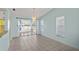 Dining area featuring sliding glass doors to patio and stylish pendant lighting at 3857 Sailmaker Ln, Holiday, FL 34691