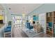 Well-lit home office space with desk, chair, patio access, and shelving at 3857 Sailmaker Ln, Holiday, FL 34691